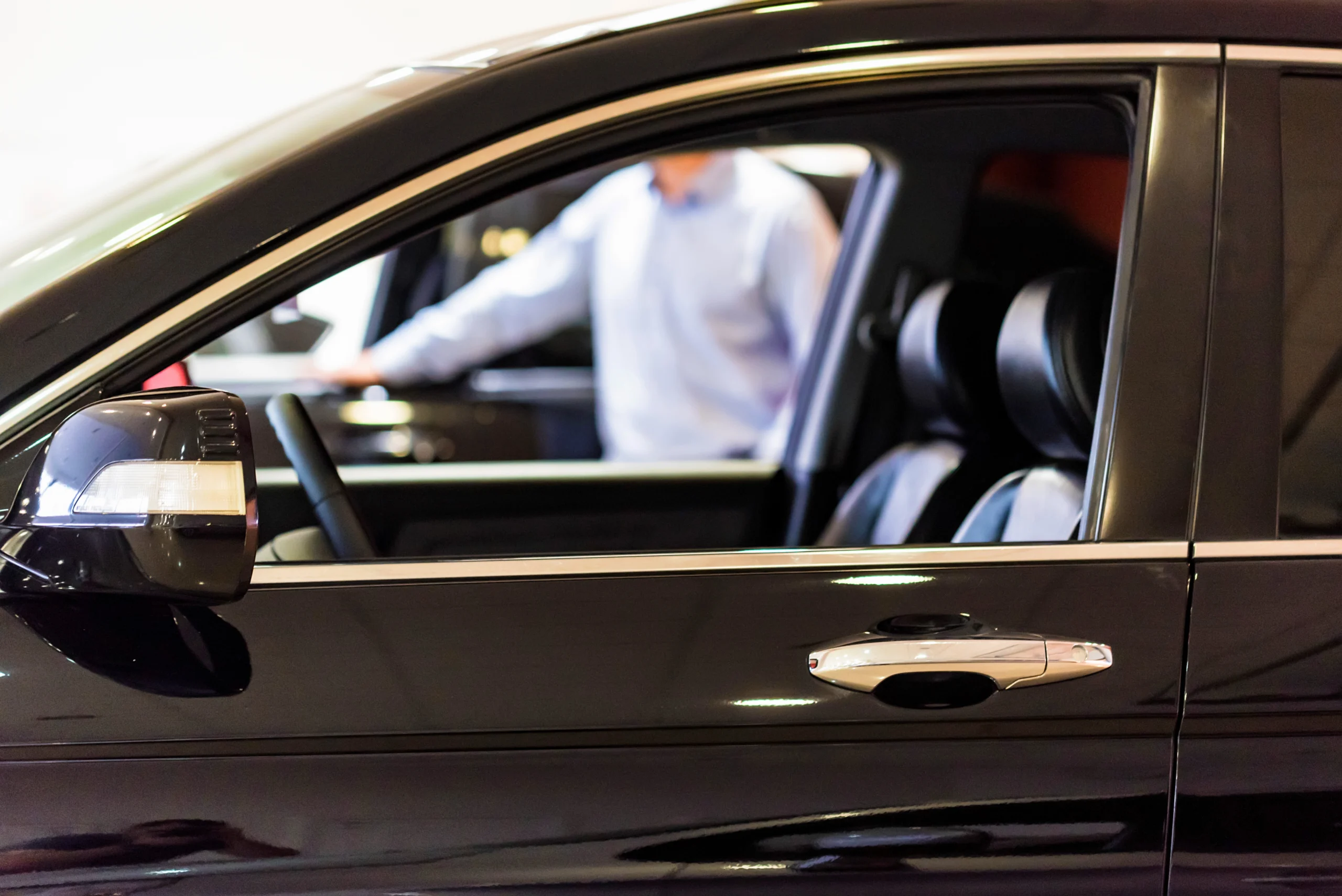 99810515_l New car at dealer showroom blurred background